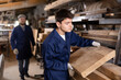 © JackF - Preparing for furniture production - furniture factory worker places a board on a cutting machine