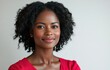© Surachetsh - A close up of a happy smiling portrait black woman with simple hair and a joyful smile in a vivid colorful shirt on clear white background.