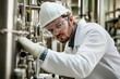 © Thanapong - Chemical engineer conducting industrial research in a laboratory setting with advanced equipment and safety gear for enhanced chemical processes and industrial innovations