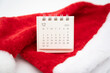 © Wongsakorn - Simple desk calendar for DECEMBER 2024 with Santa hats on white background. New year Calendar concept with copy space. 2024 DEC calendar.