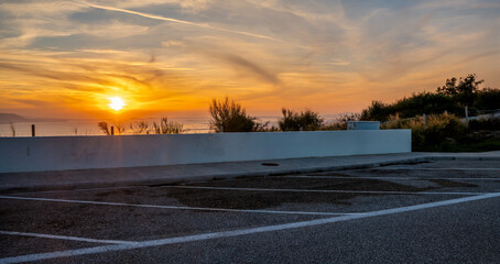 Wall Mural - highway parking lot with sunset view over the sea