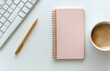 © olegganko - Workspace setup featuring a notepad, coffee cup, and keyboard for creative tasks