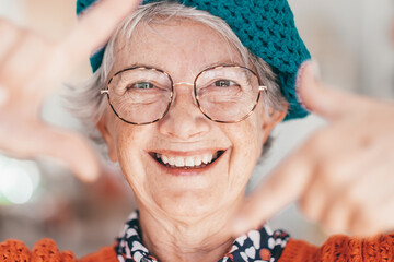 portrait of attractive carefree smiling senior woman wearing eyeglasses gesturing with hands, lookin