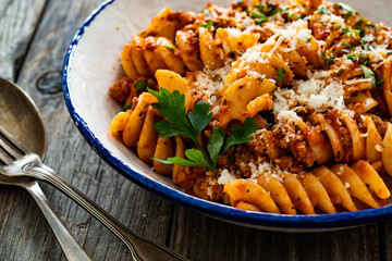 Wall Mural - Fusilli con ragù alla bolognese - pasta with minced meat and tomato sauce on wooden table