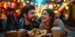 © zong - Happy couple sharing tacos at a food truck enjoying romantic dinner under warm fairy lights