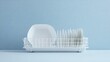 © night - White dish rack with plates on a blue counter.