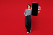 © ViDi Studio - Full body young happy woman she wear blue striped sweatshirt casual clothes hold in hand use close up blank screen mobile cell phone isolated on plain red background studio portrait Lifestyle concept