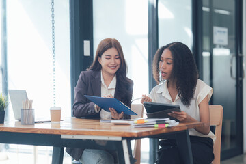 Wall Mural - Collaborative Businesswomen Reviewing Documents 