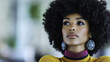 © Morninghead - woman with afro hairstyle wearing colorful earrings and stylish top
