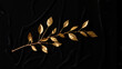© Andrey - Golden olive branch on textured black fabric