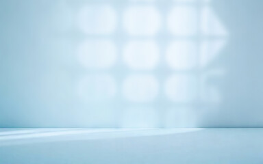 Poster - Minimalistic abstract soft blue background for product presentation with light and intricate openwork shadow from the window on the wall.