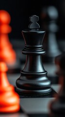 A close-up of a black king chess piece amidst blurred red pawns on a chessboard, highlighting the strategic nature of the game.