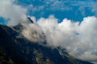 © Connect Images - Clouds shroud the rugged peaks of a mountain under a bright blue sky, Trollstiege, Trollvegen, Norway