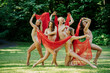 © Connect Images - Five dancers perform outdoors with a red fabric, expressing artistry and fluid movement amidst a backdrop of greenery, USA