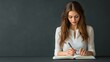 © mongkonchai - Young woman writing in notebook indoor space lifestyle photography minimalist environment focused viewpoint creative concept