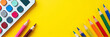 © fotoluigi868 - Back to school essentials like colorful calculators, pencils, and paints are arranged on a bright yellow background for a fun display._00001_
