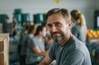 © josepperianes - Portrait of a France volunteer helping in an NGO, in the background a help center with a food bank with more volunteers working.