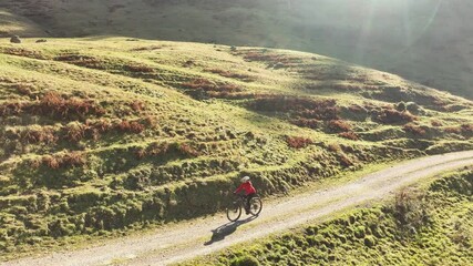 Wall Mural - active senior woman cycling with her electric mountain bike in the Bregenz Forest mountains next to Hittisauf, Vorarlberg, Austria