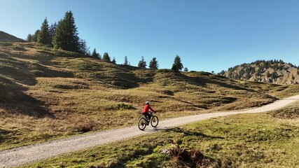 Wall Mural - active senior woman cycling with her electric mountain bike in the Bregenz Forest mountains next to Hittisauf, Vorarlberg, Austria