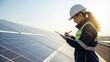 © Edwin - Female engineer in uniform with solar panel is working check and notepad quality in solar farm. solar green energy technology. Clean alternative or renewable power sources