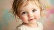 © Chexy139 - Sweet toddler with bright eyes smiles softly against a pastel background during a sunny afternoon