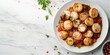 © amelisk - Saint-Jacques à la Provençale plated with scallops and sauce, marble background, ample room for text, top view.