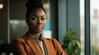 © Immersive Dimension - Confident Businesswoman In Corporate Office Wearing Stylish Orange Blazer. Professional Afro Businesswoman Portrait