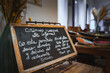 © Aerial Film Studio - Chalkboard sign in Spanish and English inside a luxury hotel. Elegant decor features dried flowers and a buffet table, reflecting Marrakech influences.