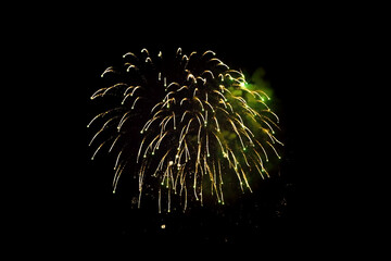 Wall Mural - single yellow fireworks closeup in black background