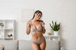 © Pixel-Shot - Young African-American woman in underwear at home