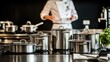 © Sampao - Stainless Steel Cookware Set in Professional Kitchen Setting