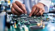 © gudangPIXEL - Close-up of technician's hands meticulously working on a circuit board.