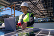 © ultramansk - Engineer inspecting solar panels with a laptop, showcasing modern technology and innovation in renewable energy. The panels reflect sunlight, emphasizing their efficiency under a clear blue sky.