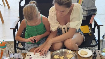 Wall Mural - Mother and her daughter paint Halloween cookies 