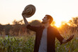 © kamonrat - Farmer Enjoying the Sunset in a Cornfield, Embracing Nature and the Golden Light, Representing Connection with the Land, Agriculture, and Peaceful Moment at the End of a Productive Day