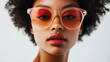 © dK - Close-up of a model in bold red sunglasses with minimalistic yet modern styling