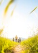 © Ryzhkov - Family Enjoying Nature Walk in Sunlit Park