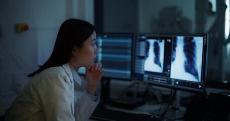 Aufkleber - Asian Female Doctor Inspecting X-ray Scans on an Advanced Diagnostic Software Technology in a Hospital in a Radiology Medical Office. Radiographer Working on a Computer, Looking at Medical Images