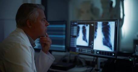 Aufkleber - Experienced Radiographer Examines Chest X-rays on Multiple Computer Monitors in a Dark Medical Room. Modern Diagnostic Equipment Ready to Take Medical Imaging Scans of a Male Patient