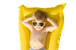 © Sunny studio - Happy child playing outdoor on summer vacation.  Kid lying on yellow inflatable mattress. Transparent  background