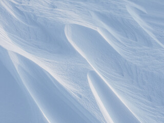 Wall Mural - snow texture. wind sculpted patterns on snow surface. wind in the tundra and in the mountains on the