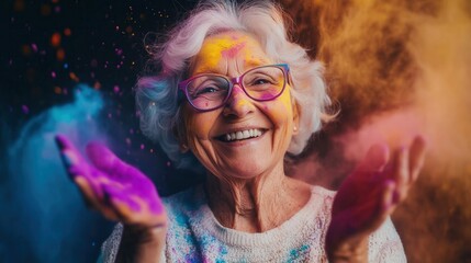 Happy senior woman celebrating holi festival with colorful powder