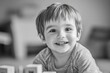 © ChaoticMind - A joyous toddler with bright eyes and a wide smile plays with blocks in a monochromatic setting, capturing a candid moment of pure childhood delight and innocence.