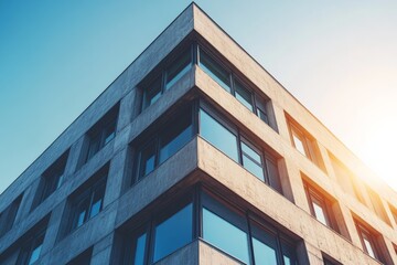 Poster - A modernist building with a clean, angular facade is starkly set against a clear blue sky, showcasing the building's sharp lines and contemporary architectural style.