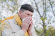 © dark_blade - young man enjoying autumn days breathing fresh air using tissue to wipe nose
