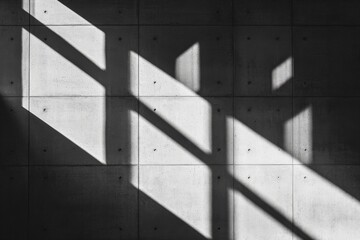 Fototapete - A contemporary image showcasing striking geometric shadow patterns cast on concrete surfaces, creating an engaging visual interplay of light and architecture.