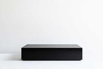 Poster - A sleek black geometric block sits in an empty, minimalist setting, featuring clean lines and stark contrast against the plain light-colored background.