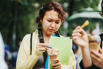 Poster - A group of diverse students savor ice cream while socializing in a park between classes, enjoying a study break. The scene captures youthful expressions and casual interaction amid green surroundings.