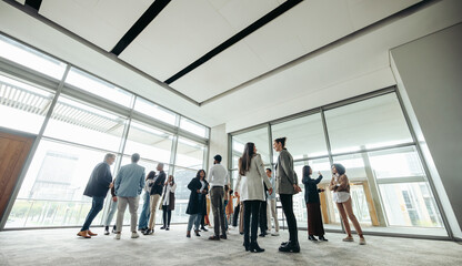 Wall Mural - businesspeople networking at corporate event in large modern office