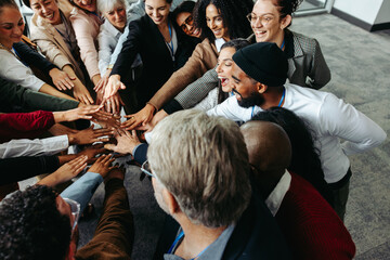 Wall Mural - diverse team showing teamwork and collaboration with hands in during corporate meeting